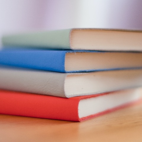Colourful books stacked horizontally